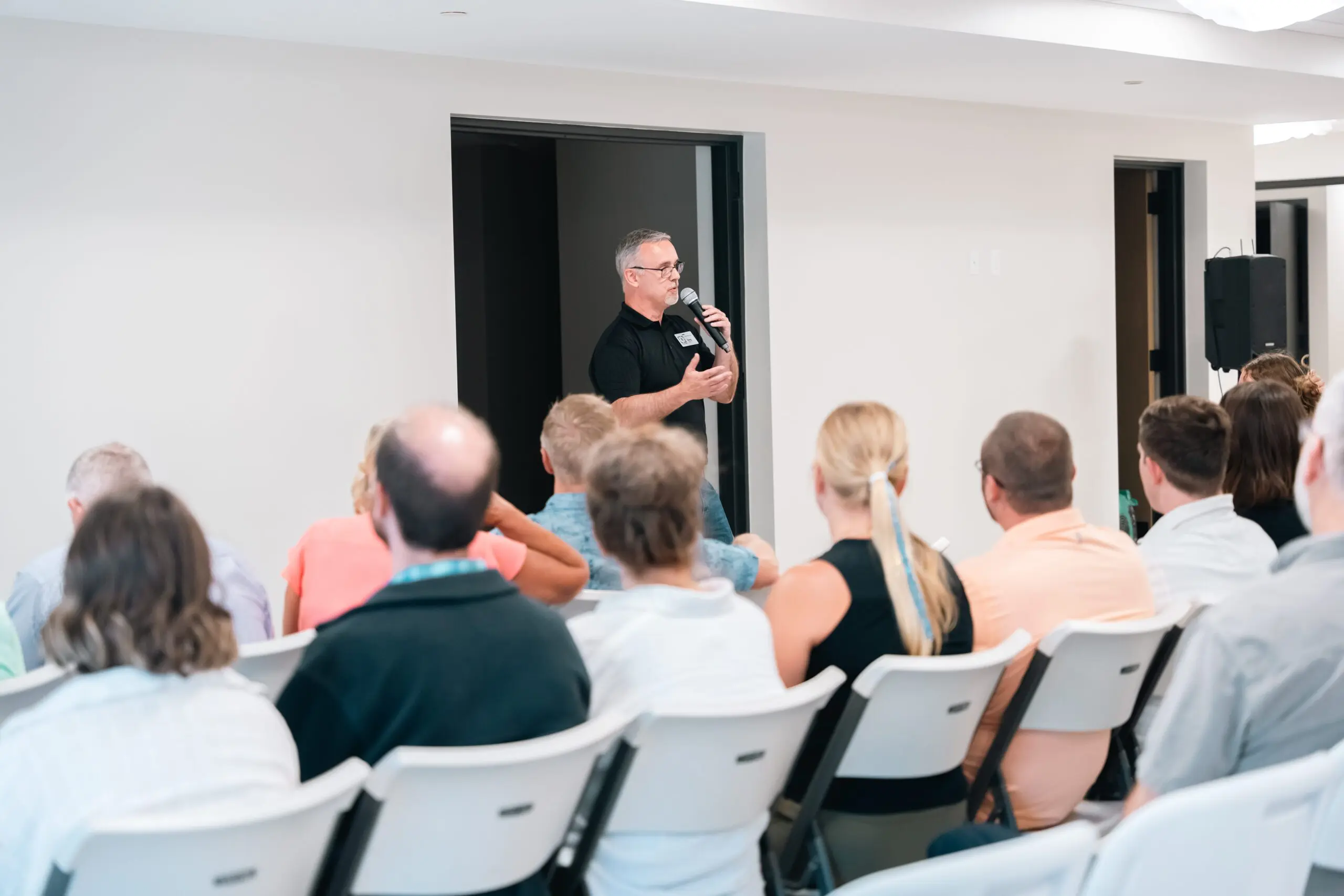 man teaching a class about finances